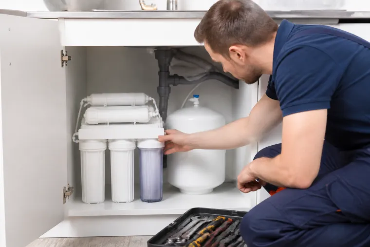 Under-sink water filtration system being serviced